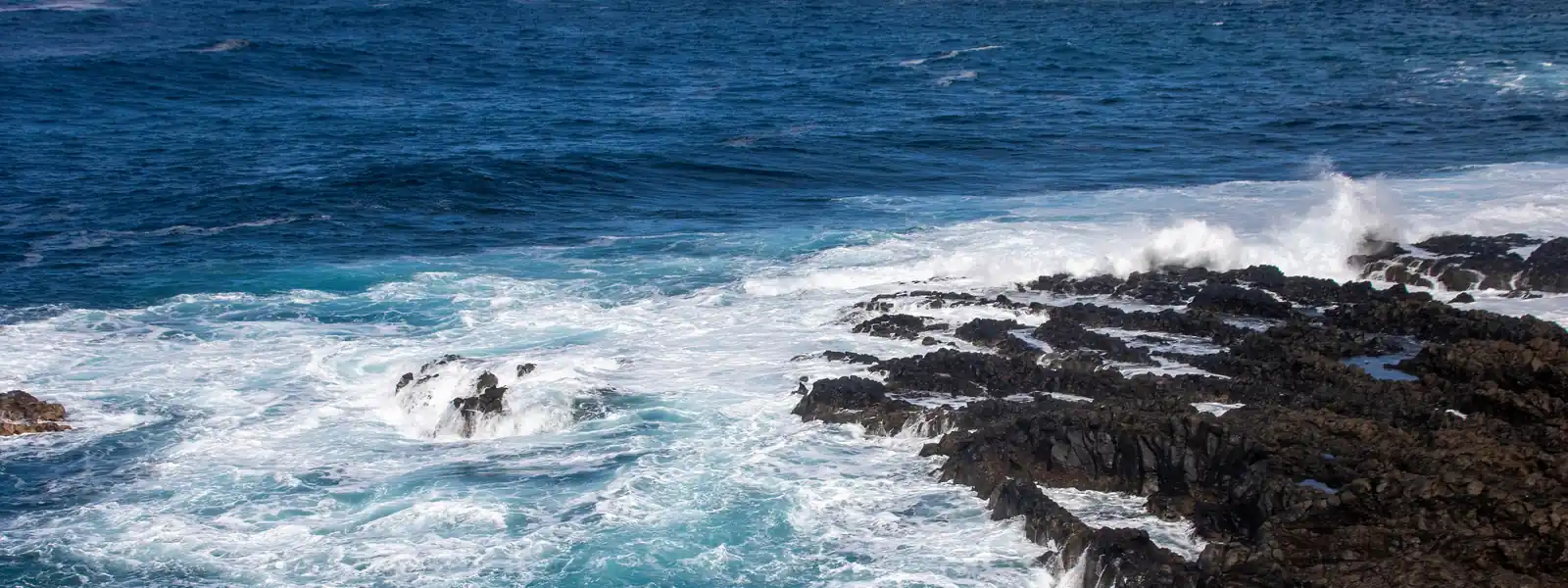The rocky coast of El Sauzal with waves breaking